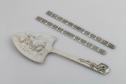 TUCK CHANG antique Chinese export silver with dragon decoration, together with a pair of Chinese silver scroll weights, 19th/20th century, (3 items), the server 25cm long, 183 grams total.