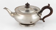 An English sterling silver teapot with timber handle and finial, retailed by William Drummond of Melbourne, made in London, circa 1929, 14cm high, 561 grams total.