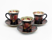 MOORCROFT "Pomegranate" set of three English pottery cups and saucers, (6 items), impressed factory mark and underglaze signatures to base, the saucers 10.5cm diameter.