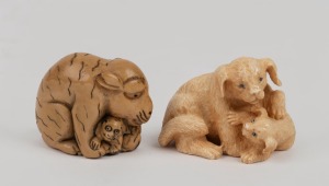 A carved mammoth ivory netsuke dog figure group; together with a carved ivory tiger and cub netsuke, the largest 4.5cm high.