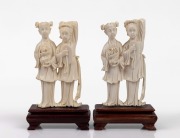 A matched pair of Chinese carved ivory figural groups on timber stands, mid 20th century, 16cm high overall.