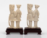 A matched pair of Chinese carved ivory figural groups on timber stands, mid 20th century, 16cm high overall. - 2