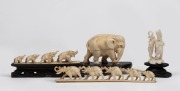 Two carved ivory elephant bridges, carved ivory elephant statue and a carved ivory elephant stand, 19th/20th century, (4 items), the largest 15cm long overall.