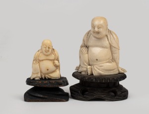 234 · Two Chinese carved ivory seated Buddha statues, both resting on carved wooden stands, 20th century, the largest 6.5cm high overall.