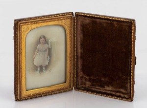 An antique photographic portrait with hand-coloured embellishments, attractively housed in a bi-fold display case with gilt metal mounts, 19th century, 12cm high.