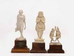 301 · Three Indian carved ivory figures on timber stands, including Mahatma Gandhi, 20th century, the largest 11cm high overall.