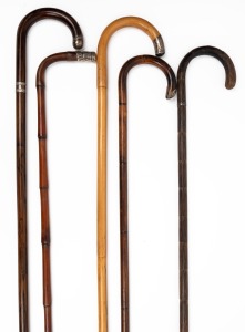 Five assorted antique and vintage walking sticks, all with silver collars and mounts, 19th/20th century, the largest 92cm high.