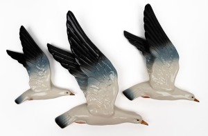BESWICK set of three English porcelain flying seagulls, mid 20th century, circular black factory mark, ​​​​​​​the largest 35.5cm long.