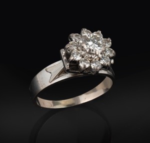 340 · A vintage 18ct white gold and diamond cluster ring, early to mid 20th century, stamped "18ct", 6.2 grams.