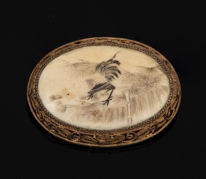 338 · An antique Chinese carved ivory brooch, set with gilded filigree silver, early 20th century, ​​​​​​​5cm wide.
