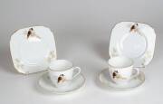KOOKABURRA TEA WARE: Pair of Bavarian porcelain cups, saucer, plates sets, decorated with kookaburra motif, mid 20th century.