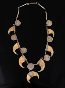 319 · An antique Indian silver necklace, set with claws and silver coins, 19th/20th century, ​​​​​​​47cm long.
