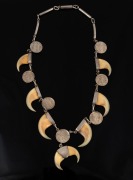 An antique Indian silver necklace, set with claws and silver coins, 19th/20th century, ​​​​​​​47cm long.