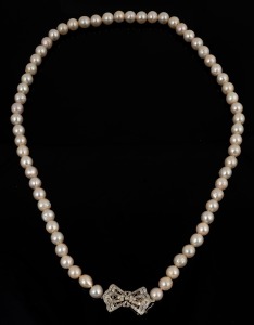 A vintage cultured pearl necklace fastened by an impressive 14ct white gold and diamond clasp, mid 20th century, 62cm long, the clasp 3cm wide.