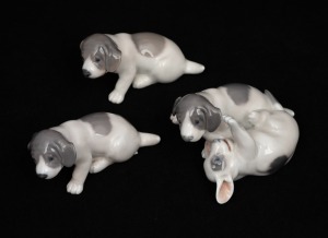 ROYAL COPENHAGEN group of three Danish porcelain puppy figures, 20th century, factory mark to base, ​​​​​​​the largest 5.5cm high, 10cm long.