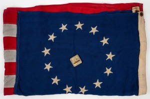 Two c. 1976 United States 13-star "Betsy Ross" flags, produced to commemorate the United States Bicentennial, both approx. 85 x 150cm, together with "SS Moldavia" mirror compact. (3 items)