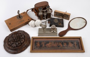 Three antique door locks, pair of porcelain doorknobs, mahogany hand mirror, antique French field glasses, carved oak roundel, pressed tin ostrich inkwell, and an antique lithograph of nymphs and putti figures, 19th/20th century, (10 items).