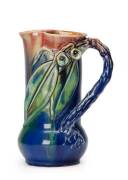 REMUED: Pottery jug with branch handle, gumnuts & leaves glazed in blue, green & pink.  19.5cm