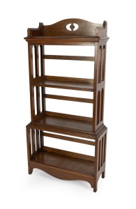 An antique English Arts & Crafts oak free standing four tier bookshelf, early 20th century, 130cm high, 62cm wide, 24cm deep.