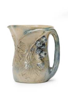 MERRIC BOYD: Pottery jug with applied grapes & leaves glazed in blue & green earthen tones. Signed & dated 1923. 15.5cm