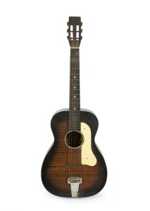 THE LIBERTY GUITAR vintage Hawaiian style acoustic guitar with original paper label, in hard case, mid 20th century, 93cm high.