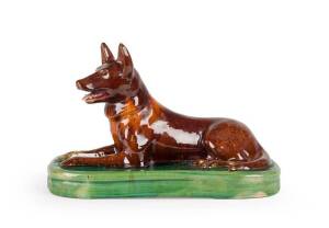 McHugh Tasmanian pottery "Kelpie" dog door stop glazed in green & brown. Height 21cm, width 33cm, depth 15cm