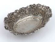 An antique sterling silver bowl with floral repousse decoration 19th/20th century, 17cm wide, 99 grams.