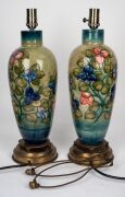 MOORCROFT "Bougainvillaea" pattern pair of porcelain table lamps on celadon green ground with brass bases and metal fittings, 50cm high overall. - 2