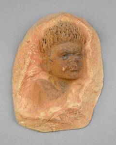 WILLIAM RICKETTS: Pottery face plaque of a boy, incised signature. 21 x 16cm