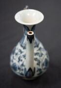 A Ming Dynasty porcelain pot (A/F), a Chinese blue and white porcelain water pot in the Yuan style (unknown age), together with an antique Chinese export ware blue and white porcelain meat platter (A/F), 18th/19th century, (3 items), the platter 46cm wide - 3