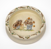 A Falcon ware 'playtime' childrens bowl decorated with koalas playing cricket, English, 20th century, 16 cm diameter.