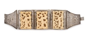 A Chinese filigree silver bracelet adorned with three finely carved ivory panels, early to mid 20th century, stamped "SILVER", 17cm long, 4.2cm wide