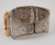 A Chinese filigree silver bracelet adorned with three finely carved ivory panels, early to mid 20th century, stamped "SILVER", 17cm long, 4.2cm wide - 2