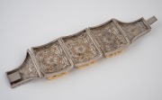 A Chinese filigree silver bracelet adorned with three finely carved ivory panels, early to mid 20th century, stamped "SILVER", 17cm long, 4.2cm wide - 3