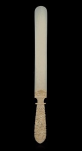 An antique carved ivory paper knife with ornate floral decoration, 19th century, 25cm long