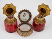 A pair of antique French ruby glass scent bottles with gilt metal mounts and hand-painted floral decoration, together with an antique French opaque glass trinket box with gilt metal mounts, enamel scene and seed pearl decoration, 19th century, (3 items), - 2