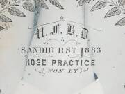 A stunning Australian silver trophy cup & cover "U.F.B.D (United Fire Brigades' Demonstration) SANDHURST 1883, Hose Practice....". Engraved with ferns & leaves with a detailed cartouche depicting fireman at work. Lid adorned with figural fireman finial. T - 2