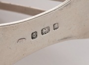A sterling silver cricket-themed napkin ring; Birmingham, 1903. Delightful piece, depicting two bats and a ball on one side and a set of wickets on the other. - 2