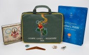 1956 MELBOURNE OLYMPICS: Seat cushion from the opening ceremony, chocolate tin, boomerang ornament and badge; together with SYDNEY 2000 badges and medallions, (qty).