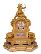 An antique French gilt spelter figural mantle clock with SEVRES French pink porcelain dial and inset panels, eight day time and bell striking movement, resting on original plinth base, 19th century, 40cm high overall.