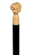 An antique walking stick with carved marine ivory snake and fist hand grip, ebony shaft and brass ferrule, 19th century, ​​​​​​​83cm high.