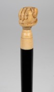An antique walking stick with carved marine ivory snake and fist hand grip, ebony shaft and brass ferrule, 19th century, ​​​​​​​83cm high. - 2