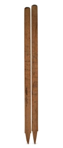 1950/51 ASHES SERIES IN AUSTRALIA: A match-used cricket stump souvenired by Bill Johnston, expertly split in half, with the Australian team signing one half and the English team signing the other (26 signatures total); length of the longer half 80cm.