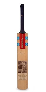 Don Bradman's original signature on a full-size Gray-Nicolls cricket bat, featuring photograph of Bradman and career statistics; length 83 cm.