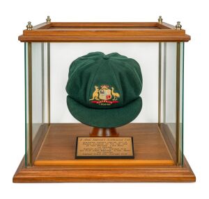 BOB SIMPSON's 1958-59 "BAGGY GREEN" Australian Test Team cap, superb condition, green wool with embroidered Australia coat of arms and series date "1958-59" likewise embroidered to the front panel, "Farmer's Sydney" maker's label to inside crown with "R. Simpson" typed on said label; housed in an attractive 36 x 40.5 x 38cm timber/glass display enclosure with engraved plaque listing Simpson's career accomplishments.
