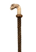 An antique French horse riding crop with finely carved bird's head handle, with decoration and gemstone eyes, engraved with the maker's details (illegible), 19th century, 80cm long.