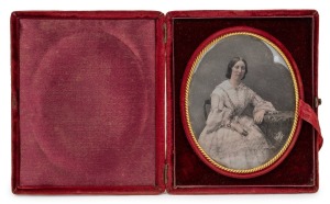 A daguerreotype oval portrait of a lady, attractively displayed in original plush velvet and silk bi-fold case, image signed lower right "Vaillai, 1857", ​​​​​​​12.5 x 10.5cm overall when closed.
