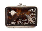 An antique tortoise shell bi-fold calling card case inlaid with silver decoration and lined in magenta silk with compartments, 19th century, 9cm wide.