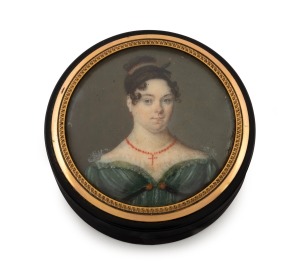 An antique English circular carved horn box bearing a fine quality portrait miniature of a young lady in Regency dress, mounted in rose gold, circa 1820s, 6cm diameter.