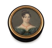 An antique English circular carved horn box bearing a fine quality portrait miniature of a young lady in Regency dress, mounted in rose gold, circa 1820s, 6cm diameter.